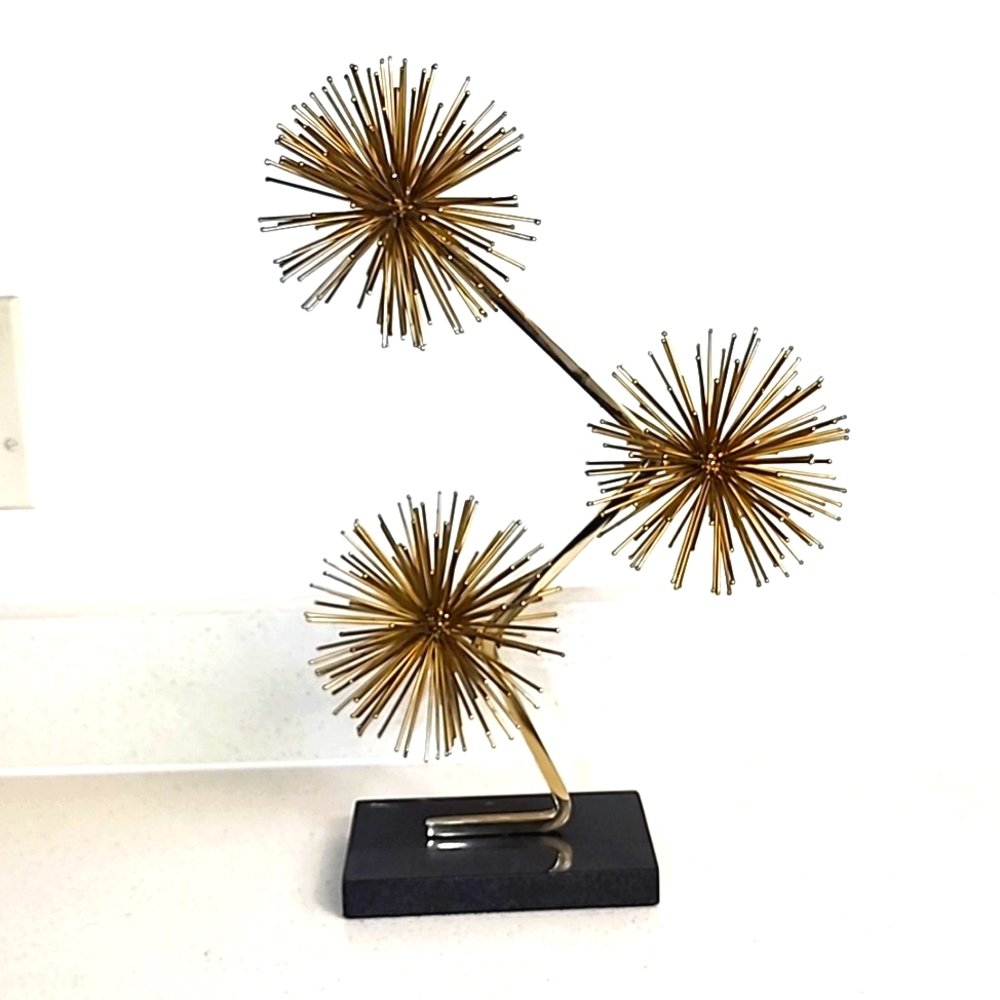 Gold Starburst mounted on black marble